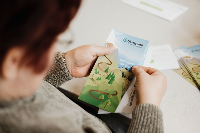 Rehakundin sortiert Flyer in ein Kuvert